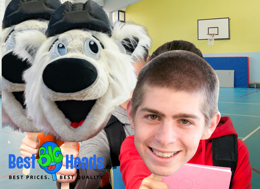 Student proudly holding a large face cutout of their school mascot during a spirited school event.
