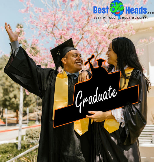 A newly graduated couple smiling and celebrating together during one of the most special milestones of their lives.