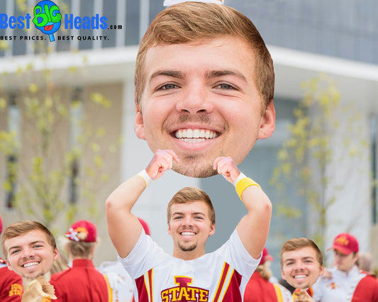 Group of students holding a Best BIG Heads™ face cutout to cheer on their team and show school spirit.