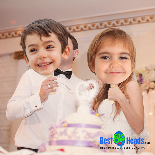 Newlyweds smiling and holding face cutouts of their childhood photos during their wedding reception.