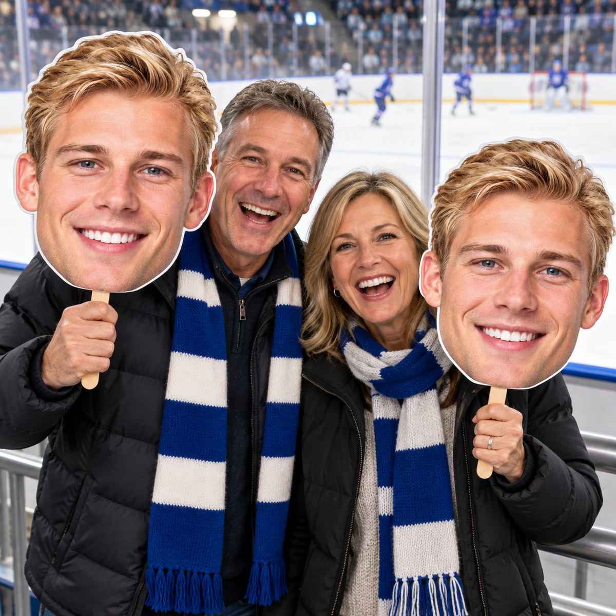 Two hockey fans holding oversized matching player face cutouts beside the ice rink