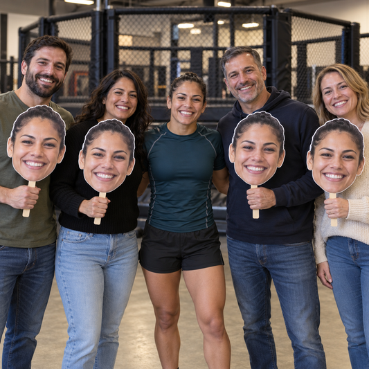 MMA athlete with four supporters holding oversized cutouts of her face in front of a training cage.