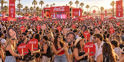 Wide illustration of festival fans holding face cutouts and red sponsor backs.
