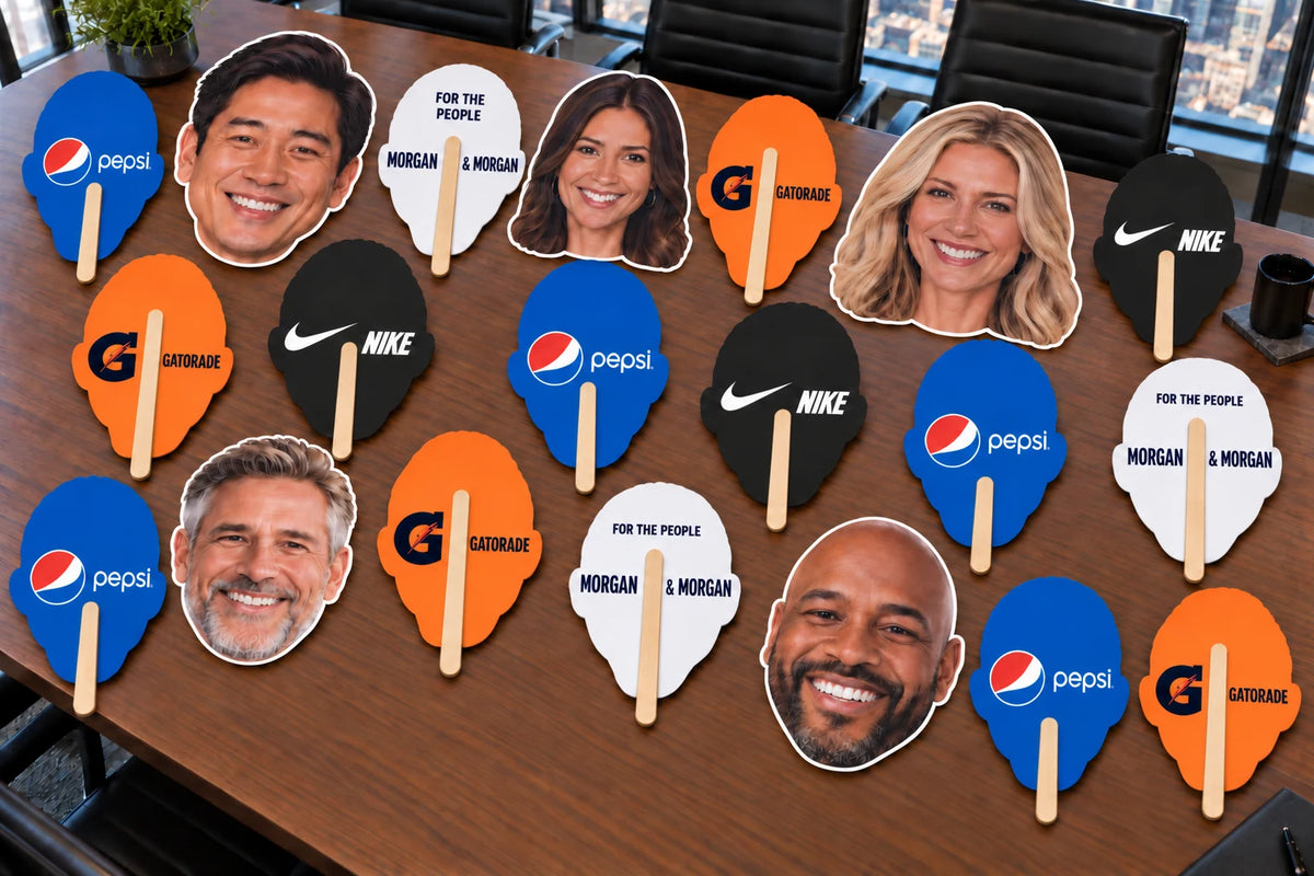 Illustration of face cutouts beside sponsor-printed backs with wooden handles.