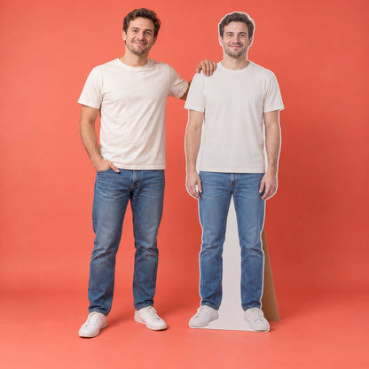 A man standing beside a matching full-body photo standee against a coral background.