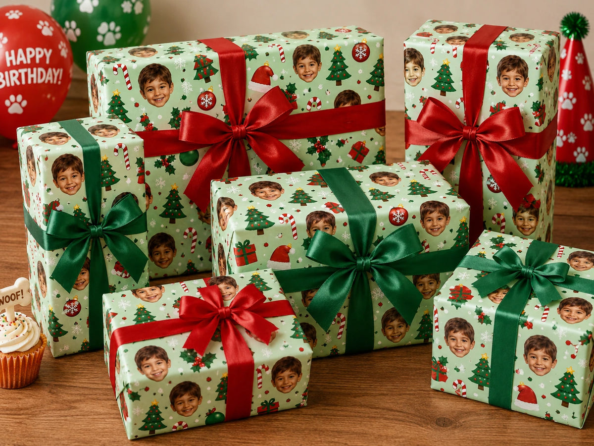 Stacked gifts wrapped in pale green Christmas 1 paper with child faces and festive icons, tied with red and green bows beside birthday decorations.
