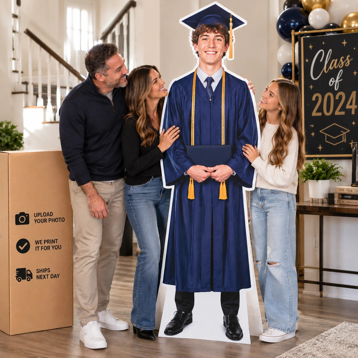 Family celebrating beside a life-size custom graduate cutout at a graduation party with 2024 decorations.
